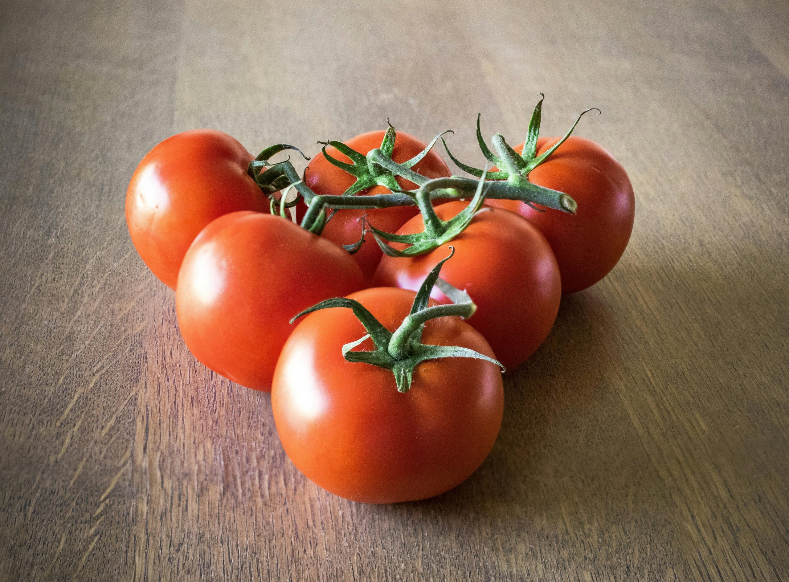 pexels photo 209401 209401 Organic Store's ripe red tomatoes on a wooden table, showcasing their vibrant color and freshness.