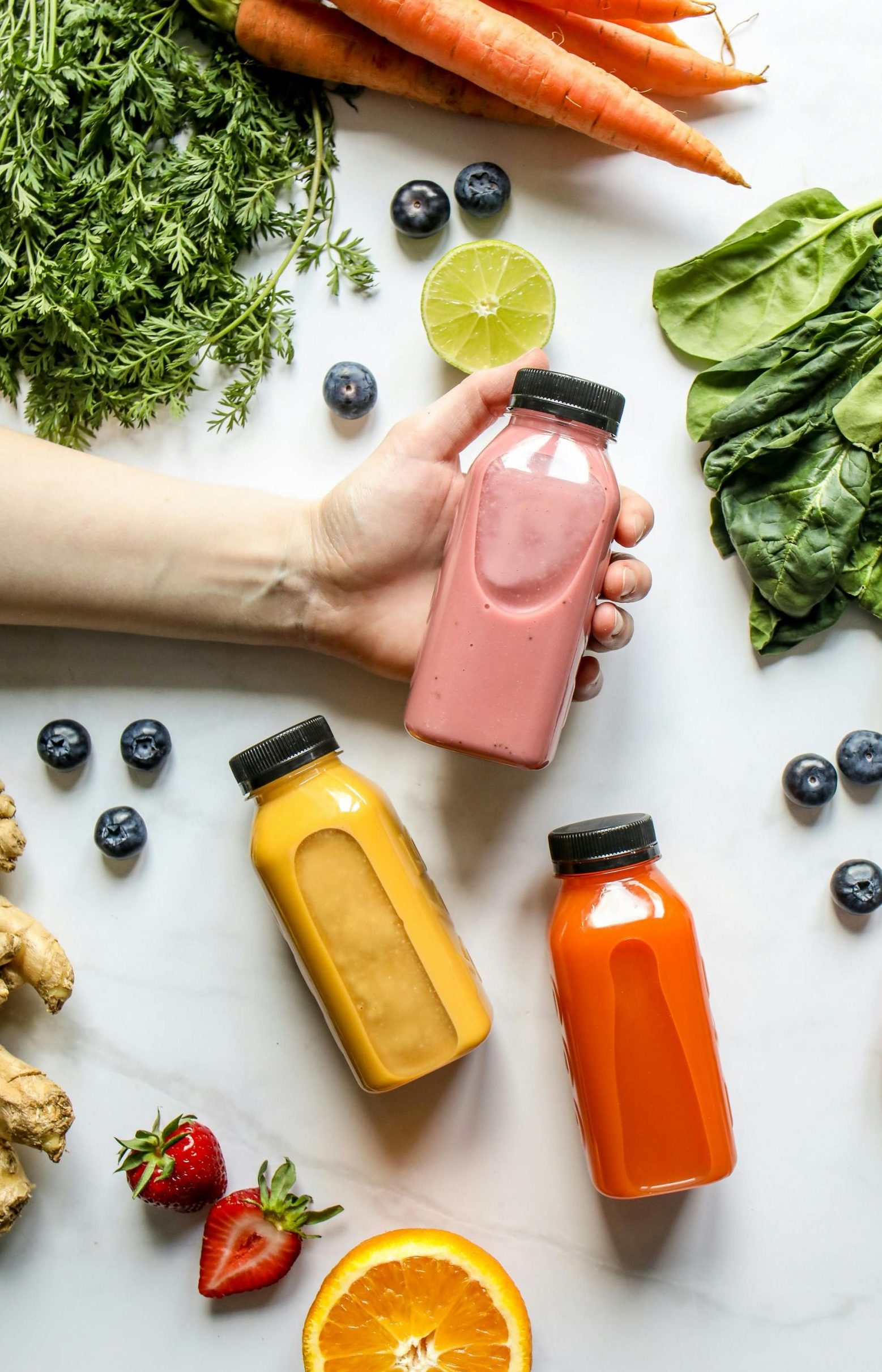 Vibrant juices from organic store, surrounded by fresh fruits and vegetables, perfect for a healthy lifestyle.